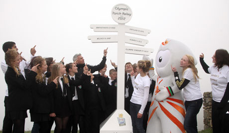 Young people from across the UK help LOCOG Board Member Jonathan Edwards and Olympic mascot Wenlock celebrate the announcement at Land's End