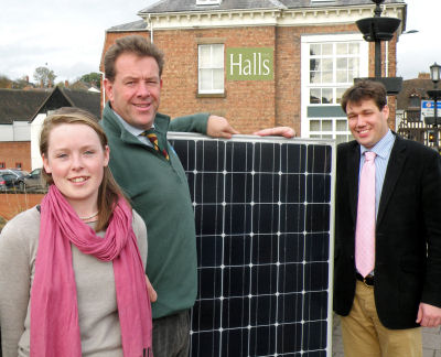 Stephen Davies, a director of The Green Electrician (centre) with Shaun Jones and Louise Roberts from Halls and a PV solar panel.