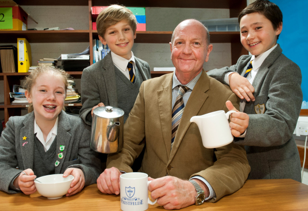 Dr Alasdair Campbell relaxes with a cup of tea made by pupils, from left, Millie Stanhope; Samual Reincke (correct) and Finn Sansom - all aged 11.