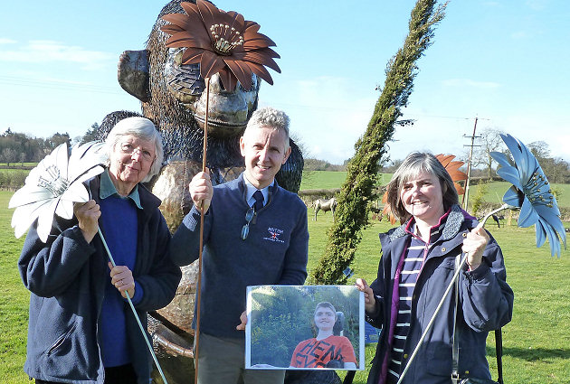 Heather Hancock (right) holds a picture of her late son, Tom, and a sunflower garden sculpture with Black Country Metalworks managing director Clive Knowles and Gillian Eleftheriou.