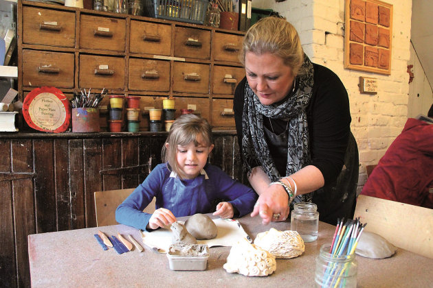 Coalport China Museum workshop Sara Robinson helps a young visitor.