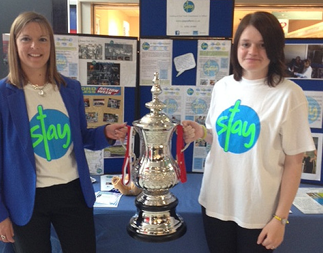 Kay Bennett of Stay Telford with Antonia, who has been helped by the charity, and the Manx Trophies FA Cup.