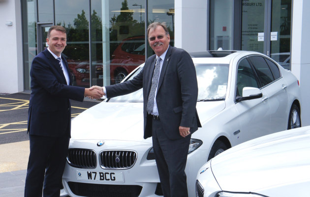 Gareth Thomas hands over the keys to two new 5-Series vehicles to David French (Right) at Rybrook BMW, Battlefield, Shrewsbury.