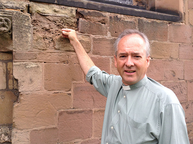 Reverend Chris Thorpe holds a piece of crumbling stonework at St Andrew’s Church, Shifnal, which fundraisers are campaigning to repair.