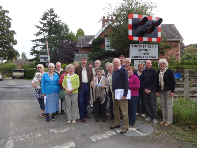 Philip Dunne with residents from Ashford Bowdler who are up in arms at the proposed closure of the level crossing which divides their village.
