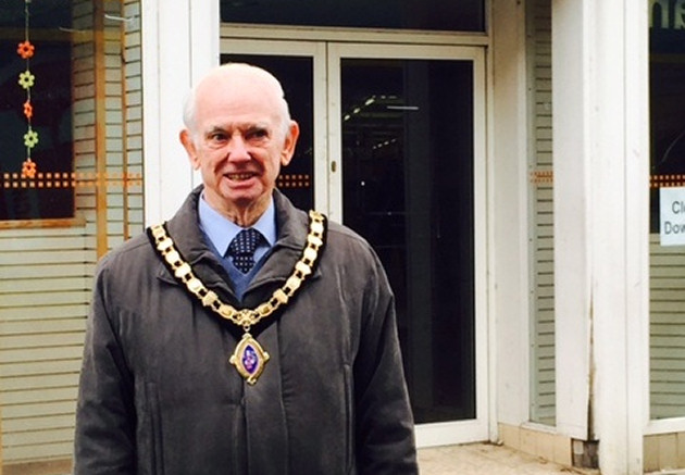 The Mayor of Oswestry, Councillor John Gareth Jones, outside an empty shop in in the town centre