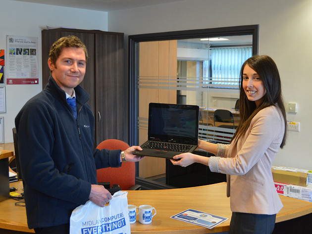 Mike Haycox of Midland Computers, Halesfield, Telford, hands over IT hardware to Rachel Ford at New College Telford