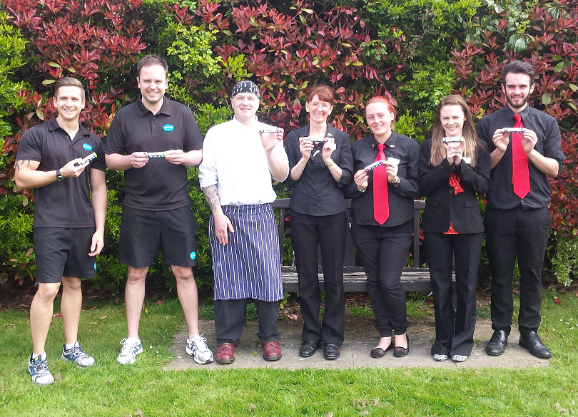 Members of staff with their Smarties tubes