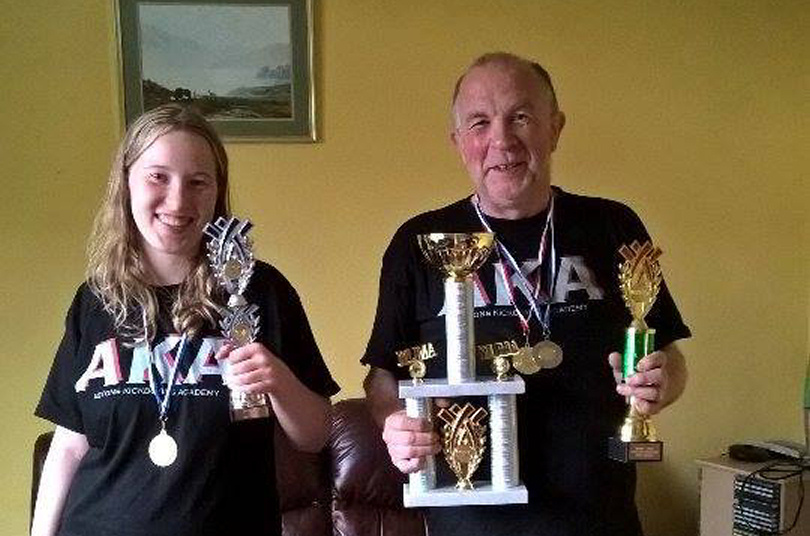 Joanne and Pete Savage with their medals and trophies