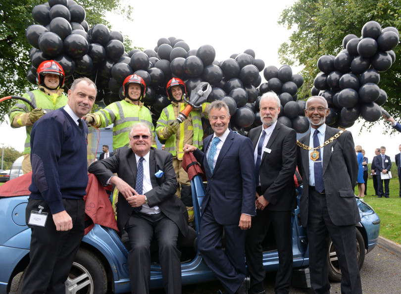 Lord Digby Jones with left to right Shropshire Chief Fire Officer John Redmond, lawyer Graham Davies, TTC Group Road Safety Director Alan Prosser and Telford Mayor Leon Murray with firefighters and black balloons after a car extrication demo as part of the business driver road safety campaign
