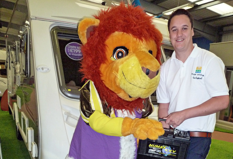 Ironbridge Lions mascot, Dandylion, accepting batteries from Scott Higgins, Sales & Marketing Manager of Salop Leisure Ltd