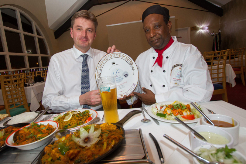 MP Daniel Kawczynski congratulates Cafe Saffron's executive chef Mohammad Azad on his 2015 Chef of the Year award