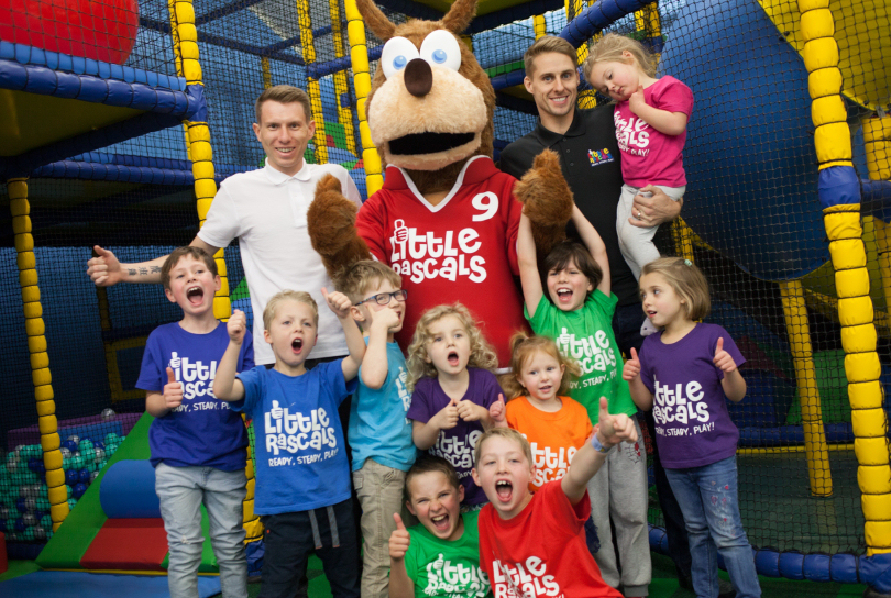 Ben Wootton, back left, and Wolves footballer Dave Edwards, back right, the co-owners of Little Rascals, get ready for Sunday's official opening of their soft play centre in Shrewsbury with excited children