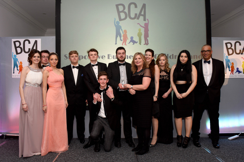 Business Students being presented an award, Business Lecturer Sarah Probert fourth from right