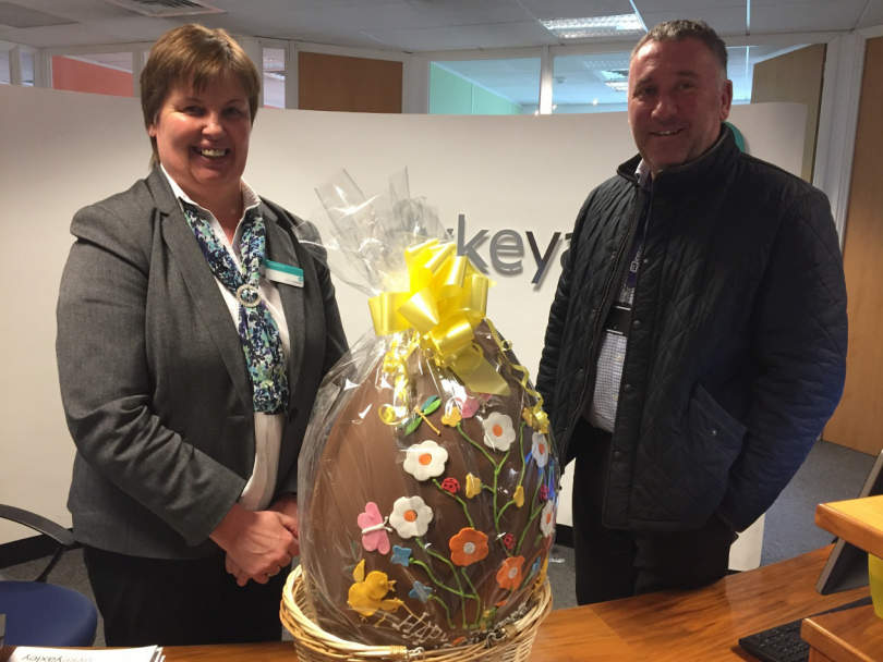 Sandra Evans presents the giant Easter egg to winner Anthony Chesworth of Insurethat at Dyke Yaxley’s offices in Shrewsbury