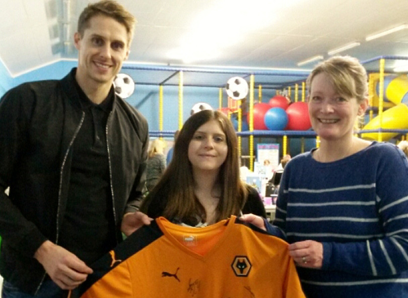 Wolves and Wales footballer Dave Edwards, the co-owner of Little Rascals indoor soft play centre, with Sarah Gibson, centre, and Sally Johnson, from the Harry Johnson Trust, with the Wolves shirt which is now available to the highest bidder