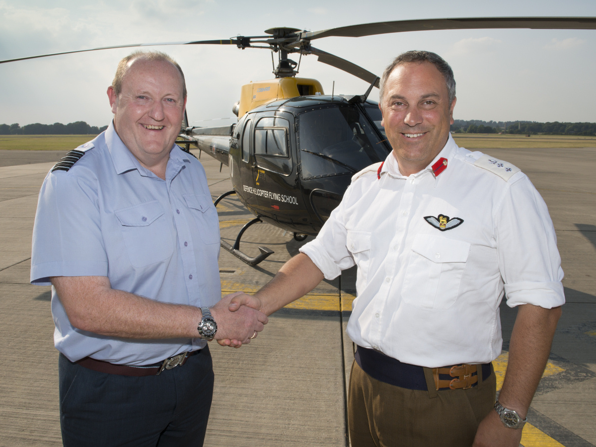 Colonel Jules Facer (right) hands over command of the Defence Helicopter Flying School (DHFS) at RAF Shawbury to Group Captain Rob ‘Chuck’ Norris