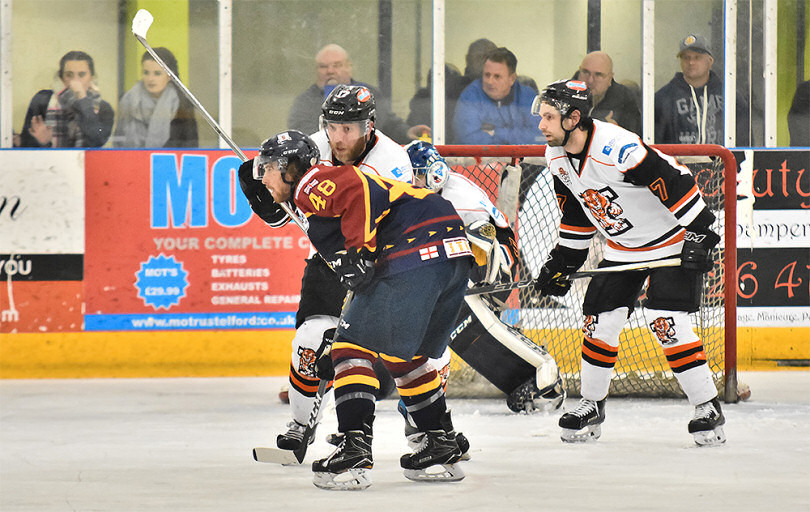 Rick Plant and Sam Oakford keep an eye on the puck against Guildford Flames on Wednesday night. Photo: Steve Brodie