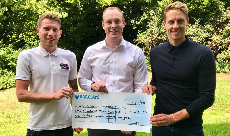 David Wells, centre, presents the cheque to Ben Wootton, left, and footballer Dave Edwards, from the Little Rascals Foundation