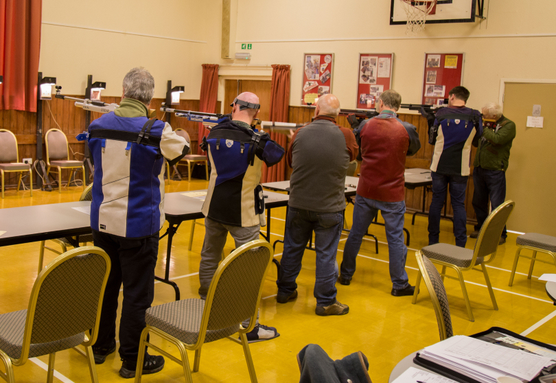 Competitors shoot at the Paper Targets In Victoria Hall