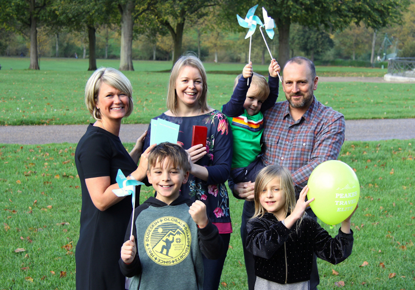 Claire Moore (left), of Peakes Travel Elite, hands the holiday prize to Claudia Baker alongside husband Tom with son Sebastian, 3, and (front) Ivan, 9, and Beatrice, 7