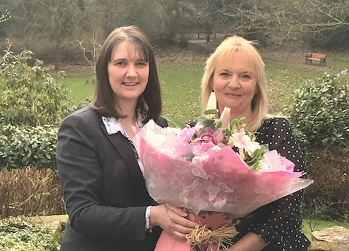 General Manager Jo Boddison presents and mum of the year winner Jude Ayling-Whitehouse with a bouquet of flowers