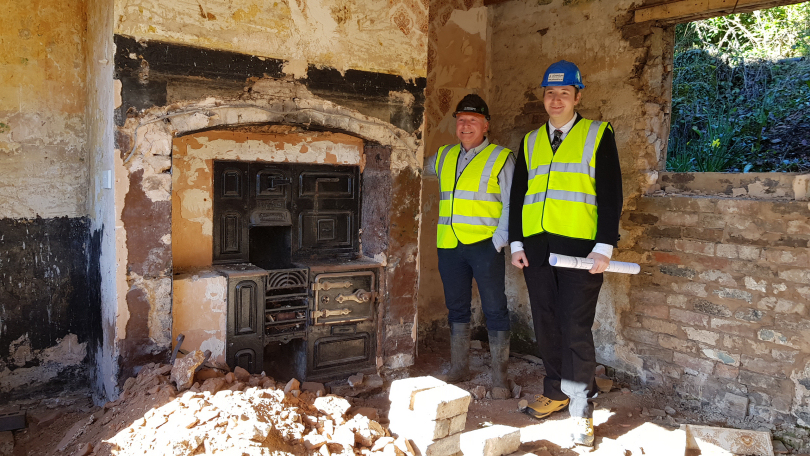 Ross Hennigan and John Turner inside one of the cottages