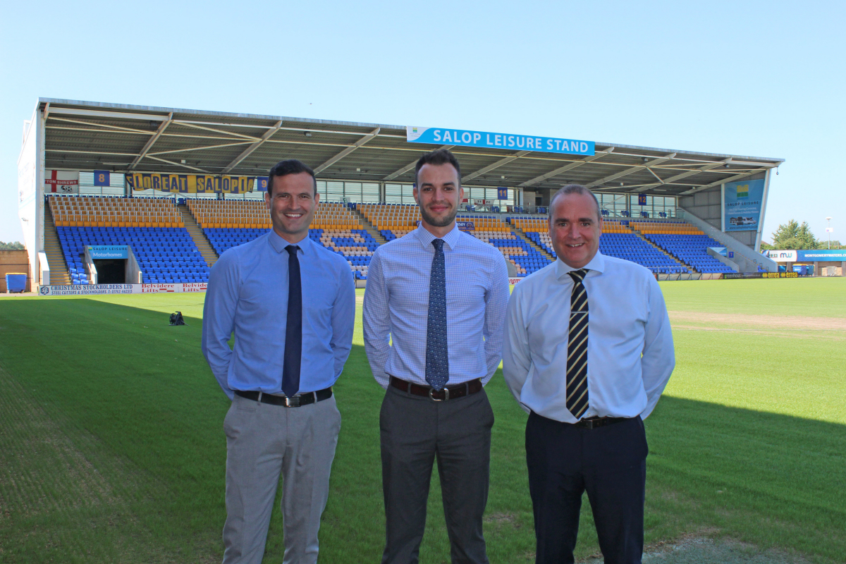 Salop Leisure’s marketing manager Ed Glover (centre) with Shrewsbury Town’s commercial manager Andy Tretton (left) and chief executive Brian Caldwell with the Salop Leisure stand in the background