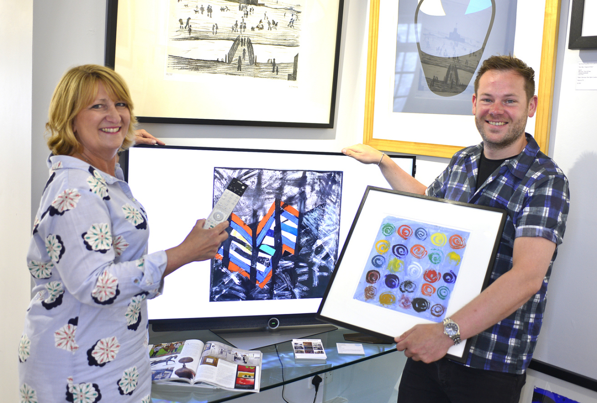 Tina Boyle of Acoustic Boutique and Jonathan Soden of The Soden Collection with the television in the gallery