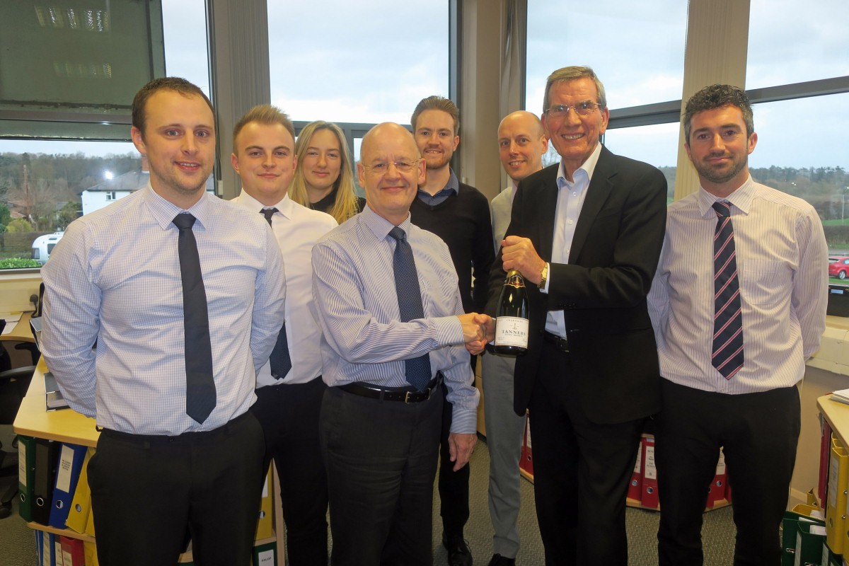 Stephen Higgins receives a bottle of champagne and a cheque from Salop Leisure’s chairman Tony Bywater to mark his 25 years’ service watched by the company’s accounts team