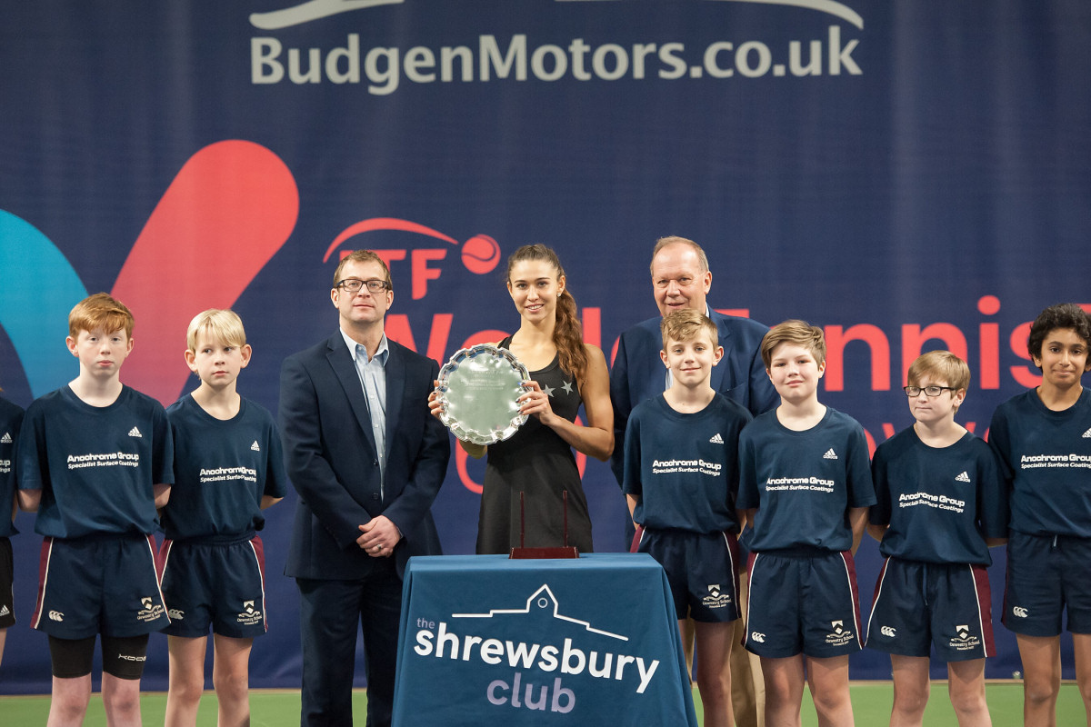 Vitalia Diatchenko, the singles champion, with, left, James Martin, the managing director of tournament sponsors Budgen Motors, and David Rawlinson, the deputy president of the LTA, at the presentation ceremony, together with members of the ball crew. Photo: Richard Dawson Photography