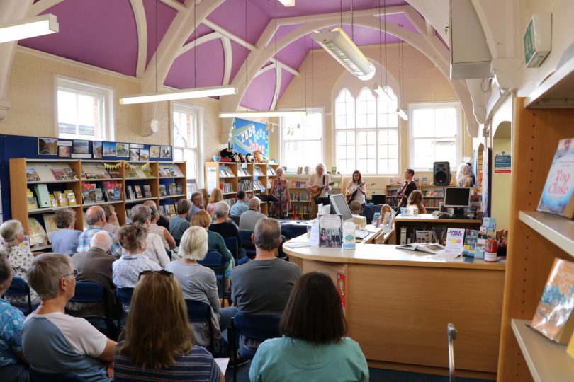 Whalebone folk group addressing a gathering at Church Stretton Library on Music and Poetry