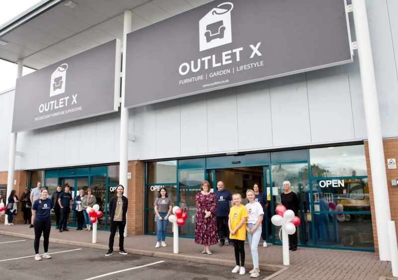 Liz Lowe, Head of Estates at Morris Property (centre in floral dress) with the Outlet X team and shoppers