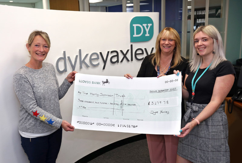 Sally Johnson from The Harry Johnson Trust is handed the cheque from Jackie Young and Mel Edwards of Dyke Yaxley