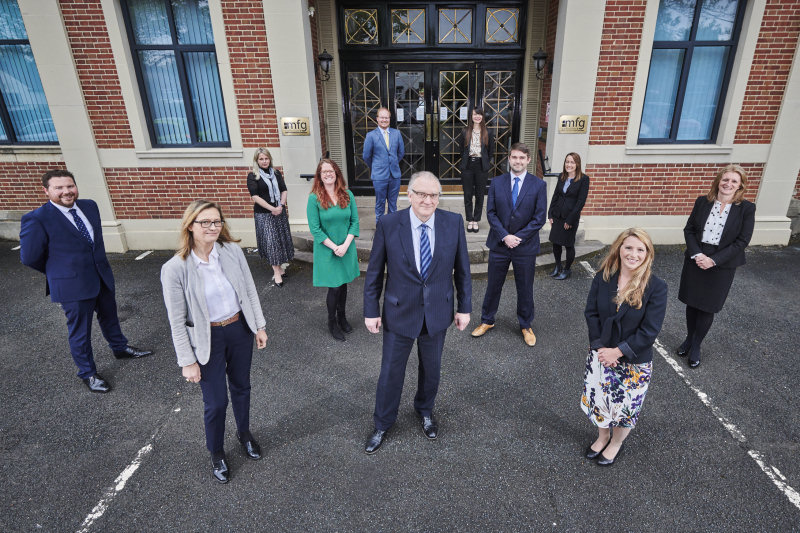 Maynard Burton (centre) with newly promoted lawyers from mfg Solicitors LLP