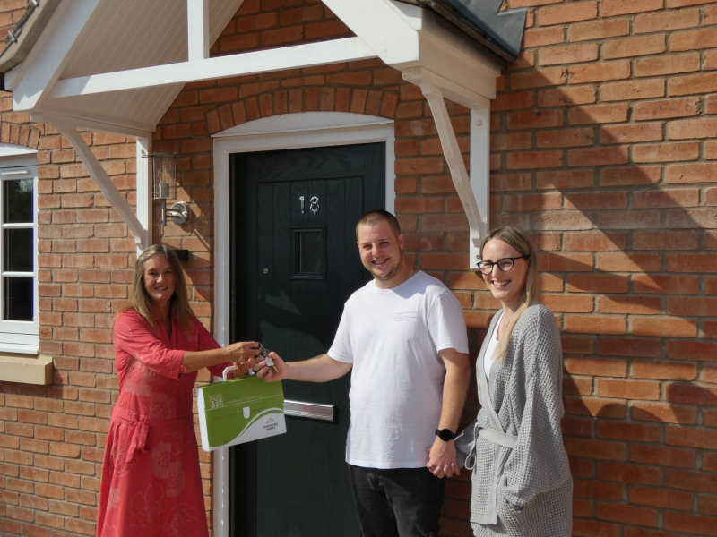 Linda Talbot, housing officer at Shropshire Rural Housing Association, hands over the keys to new tenants Tom Rogers and Cherie Williams