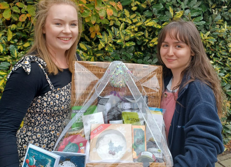 Lizzy Coleman and Nieve Murray from Lingen Davies with a selection of cards on offer, and a brilliant hamper that is available to win through the annual raffle
