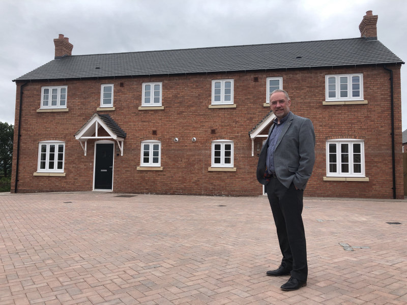 John Green, chief executive of Shropshire Rural Housing Association at a recently-completed housing development in Telford