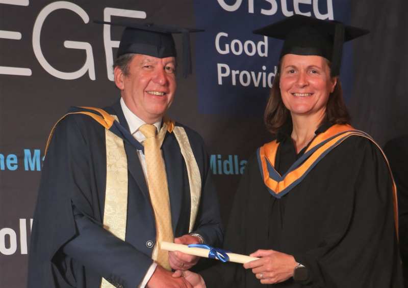Ruth Ross receives her diploma scroll from Telford College principal Graham Guest