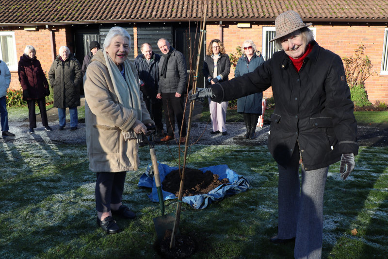 Willow Court resident, Gwyneth Jackson, helping Madge Shineton (right) plant the commemorative tree