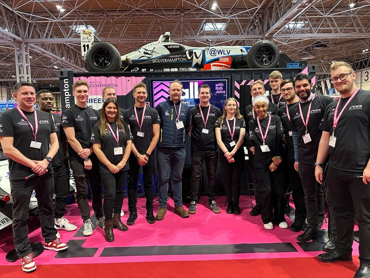 James Worthington of MyWorkwear pictured with members of the UWR team wearing their MyWorkwear kit at the Autosport exhibition in January 2024.