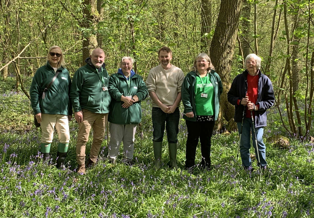 Members of Shrewsbury Macmillan Cancer Support Fundraising Group with Tim Ashton from Soulton Hall in the bluebell wood.