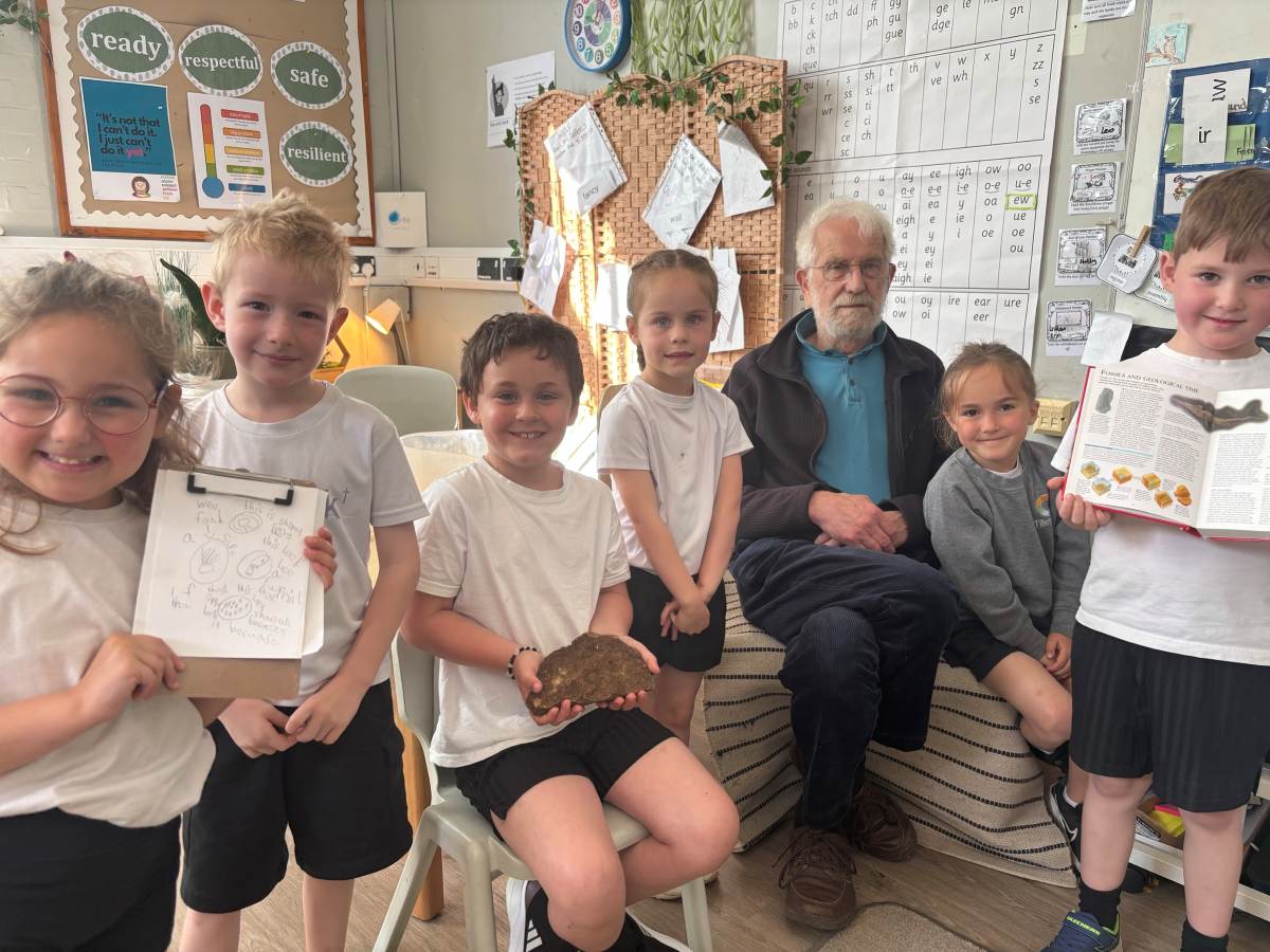 Peter from Shropshire Wildlife Trust pictured with pupils at Tilsock CE Primary School and fosil