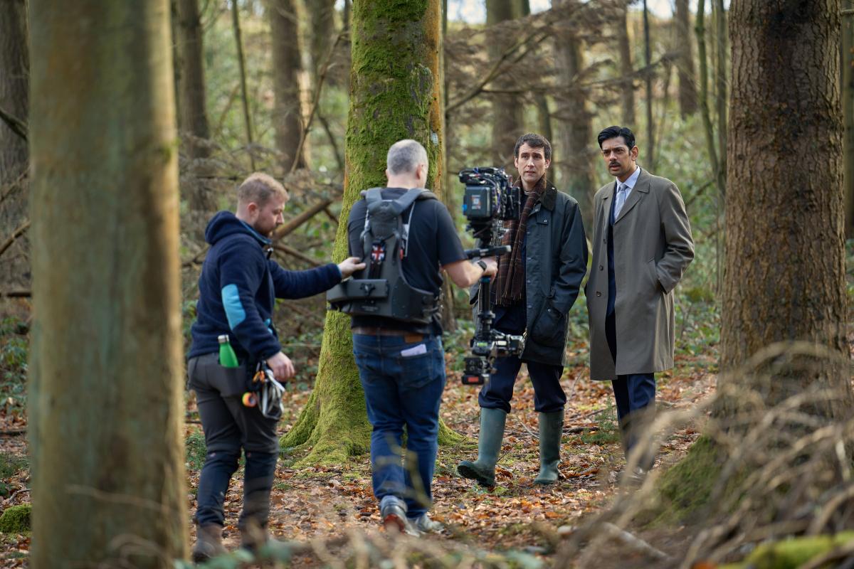 Pictured filming Murder Before Evensong at Comer Woods are Matthew Lewis as Canon Daniel Clement and Amit Shah as DS Neil Vanloo. Photo: Channel 5 / Paramount Productions