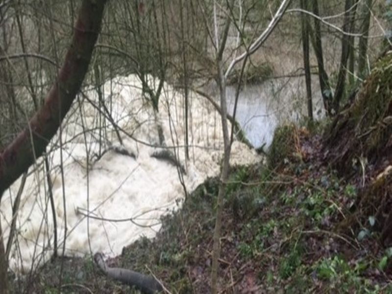 The photograph shows foam in the quarry lagoon. Photo: Environment Agency